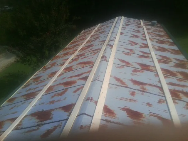 Rusted metal roof panels with new wood purlins before replacement — Storm Damage Roof Repair in Clarksboro by Roofing Brothers