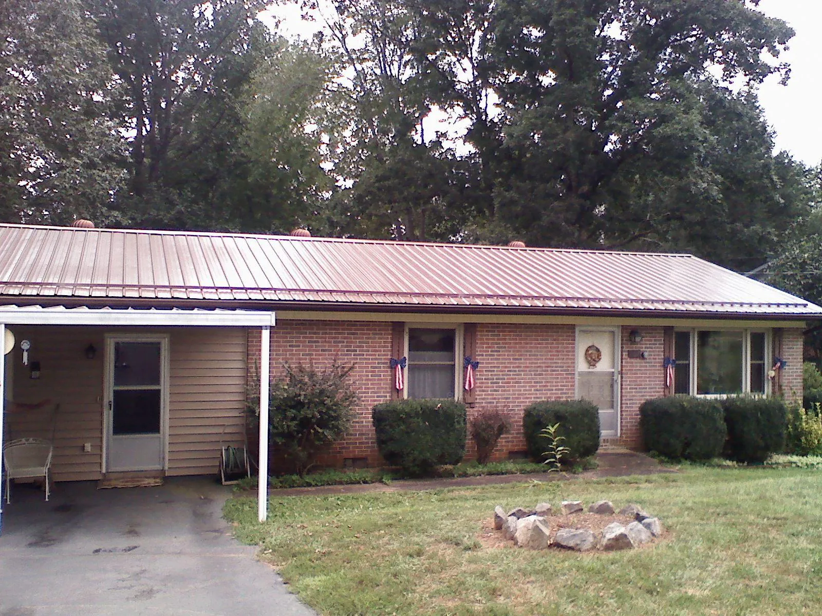 Bronze metal roof and carport on a brick ranch home — Roof Repair work by our crew in Clarksboro